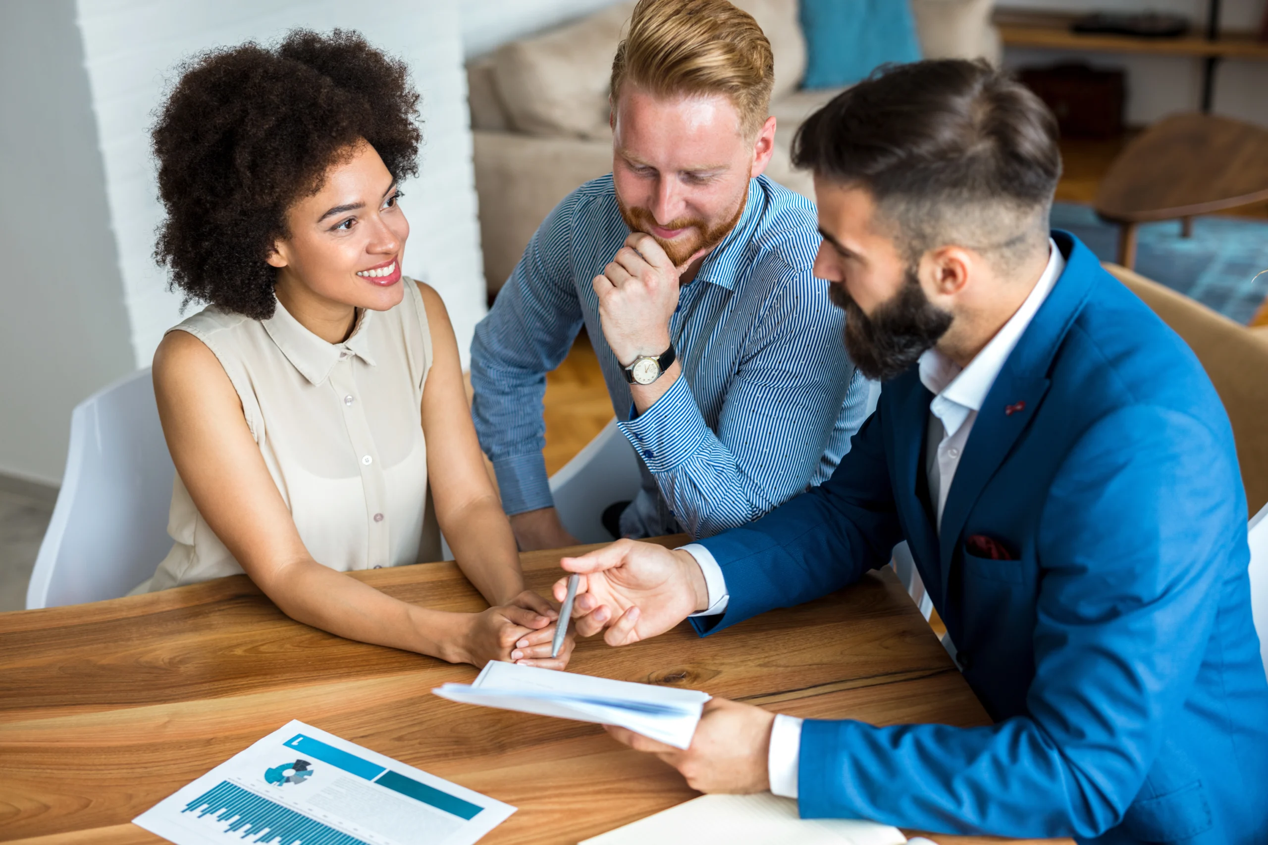 Young couple with a real estate agent. Buying new house.